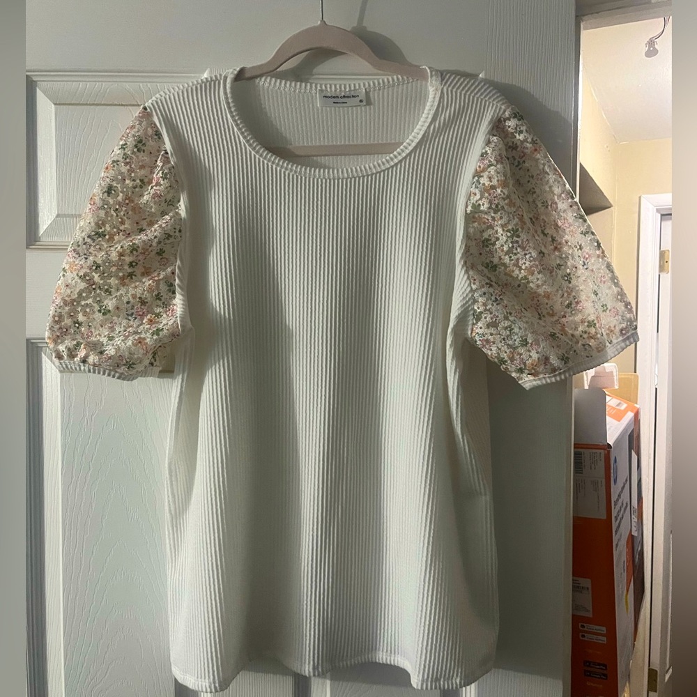 White blouse with floral details on sleeves